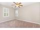 Bedroom with a ceiling fan, two windows with white shutters, and neutral walls at 5033 Knightsbridge Way, Raleigh, NC 27604