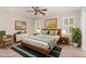 Beautiful bedroom with a ceiling fan, shuttered windows, a wooden bed frame, and neutral walls at 5033 Knightsbridge Way, Raleigh, NC 27604