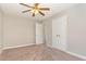Bedroom with a ceiling fan, double closets, and neutral walls at 5033 Knightsbridge Way, Raleigh, NC 27604