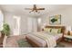 Inviting bedroom featuring a ceiling fan, neutral walls, and a wooden bed frame at 5033 Knightsbridge Way, Raleigh, NC 27604