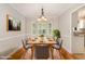 Cozy dining room with a wooden table, seating for six, and a bay window offering natural light at 5033 Knightsbridge Way, Raleigh, NC 27604