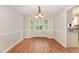 Inviting dining room boasts hardwood floors, wainscoting, and a bright bay window perfect for Gathering meals at 5033 Knightsbridge Way, Raleigh, NC 27604