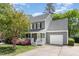 Gray two-story home with a covered front porch, attached garage, and beautifully landscaped front yard at 5033 Knightsbridge Way, Raleigh, NC 27604