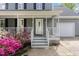 Close-up of the front porch with white railings and steps, leading to a front door at 5033 Knightsbridge Way, Raleigh, NC 27604
