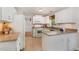 Updated kitchen features white cabinets, granite countertops, tile flooring and a view to an adjacent room at 5033 Knightsbridge Way, Raleigh, NC 27604