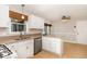 Bright kitchen with granite countertops, stainless steel appliances, and white cabinets at 5033 Knightsbridge Way, Raleigh, NC 27604