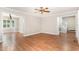 Open-concept living area with hardwood floors leads to dining room and stairway, perfect for entertaining guests at 5033 Knightsbridge Way, Raleigh, NC 27604