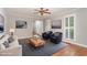 Staged living room featuring hardwood floors, fireplace, ceiling fan, and comfortable seating arrangements at 5033 Knightsbridge Way, Raleigh, NC 27604