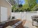 Small fenced backyard with a white fence, wood mulch and a stone paver walkway at 5044 Brooke Lauren Ln, Raleigh, NC 27616