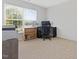Bright bedroom with neutral carpet, large window, providing lots of natural light and a desk setup at 5044 Brooke Lauren Ln, Raleigh, NC 27616