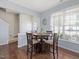 Cozy dining area with hardwood floors, a round table, and natural light from the nearby window at 5044 Brooke Lauren Ln, Raleigh, NC 27616