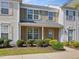 Charming townhouse featuring a brick facade, green shutters, and well-maintained landscaping at 5044 Brooke Lauren Ln, Raleigh, NC 27616