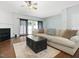 Spacious living room with hardwood floors, fireplace, a cozy sofa, and sliding glass doors at 5044 Brooke Lauren Ln, Raleigh, NC 27616
