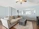 Cozy living room featuring a ceiling fan, light blue walls and a comfortable sectional sofa at 5044 Brooke Lauren Ln, Raleigh, NC 27616