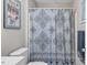 Neat bathroom features patterned shower curtain and complementary wall decor at 5064 Murrell Dr, Oxford, NC 27565
