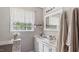 Bathroom featuring dual sinks, white cabinets, and decorative towels at 5064 Murrell Dr, Oxford, NC 27565