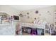 Charming bedroom featuring a modern loft bed and stylish decor with mounted TV and shelving at 5064 Murrell Dr, Oxford, NC 27565