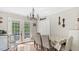Bright dining room with chandelier lighting and views of the backyard through the sliding glass doors at 5064 Murrell Dr, Oxford, NC 27565
