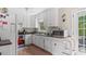 Bright kitchen features white cabinets, stainless steel appliances, and access to the deck at 5064 Murrell Dr, Oxford, NC 27565
