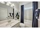 Bathroom featuring a tile wall, shower with a navy curtain, vanity, and light fixtures at 52 E American Marigold Dr # 63, Benson, NC 27504