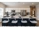 Modern kitchen island with white countertops, seating, and stainless steel appliances at 52 E American Marigold Dr # 63, Benson, NC 27504