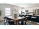 Charming eat-in kitchen area with white cabinets, stainless steel appliances, and modern furnishings at 52 E American Marigold Dr # 63, Benson, NC 27504