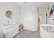Decorated Bedroom with a crib, changing table and dresser, and round mirror at 5616 Horsewalk Cir, Raleigh, NC 27606