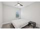 Simple bedroom with a ceiling fan, bed, side table, and window with blinds at 5616 Horsewalk Cir, Raleigh, NC 27606