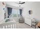 Decorated Bedroom with a crib, changing table and dresser, and seating area by the window at 5616 Horsewalk Cir, Raleigh, NC 27606