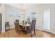 Dining room featuring a wood table, upholstered chairs and modern lighting at 5616 Horsewalk Cir, Raleigh, NC 27606