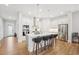 Modern kitchen with an island and bar seating, stainless steel appliances and white cabinetry at 5616 Horsewalk Cir, Raleigh, NC 27606