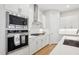 Modern kitchen featuring stainless steel appliances and white cabinetry at 5616 Horsewalk Cir, Raleigh, NC 27606