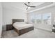 Spacious main bedroom features a tray ceiling, ceiling fan, and large windows at 5616 Horsewalk Cir, Raleigh, NC 27606
