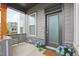 Cozy front porch with stone accents, hydrangeas, and grey painted wood at 5616 Horsewalk Cir, Raleigh, NC 27606