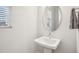 Simple powder room with pedestal sink and mirror at 5616 Horsewalk Cir, Raleigh, NC 27606