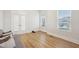 Bright sitting room with wood floors and large windows at 5616 Horsewalk Cir, Raleigh, NC 27606