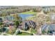 Aerial view of stunning home, showcasing lush landscaping, water, and neighborhood at 595 Legacy Falls N Dr, Chapel Hill, NC 27517