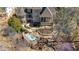 Aerial view of stunning home, landscaping, hardscape patios and the back of the home at 595 Legacy Falls N Dr, Chapel Hill, NC 27517