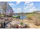 A beautiful backyard area with a landscaped overlook to a quiet pond setting at 595 Legacy Falls N Dr, Chapel Hill, NC 27517