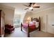 Cozy bedroom with a four-poster bed and a window overlooking the backyard at 595 Legacy Falls N Dr, Chapel Hill, NC 27517