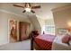 Comfortable bedroom with a ceiling fan, large armoire, and an adjoining bathroom provides a relaxing retreat at 595 Legacy Falls N Dr, Chapel Hill, NC 27517