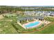 Aerial view of a community pool, clubhouse, tennis court, and surrounding neighborhood at 595 Legacy Falls N Dr, Chapel Hill, NC 27517