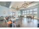 Bright community dining area featuring large windows, elegant chandeliers, and comfortable seating with a view of the pool at 595 Legacy Falls N Dr, Chapel Hill, NC 27517