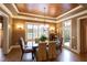 Formal dining room with elegant chandelier, wood ceiling, and large windows offering natural light at 595 Legacy Falls N Dr, Chapel Hill, NC 27517