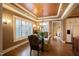 Elegant dining room featuring a wood ceiling, a chandelier, large windows with outdoor views at 595 Legacy Falls N Dr, Chapel Hill, NC 27517