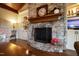 Close-up of a stone fireplace with a wooden mantel and built-in shelving at 595 Legacy Falls N Dr, Chapel Hill, NC 27517
