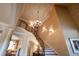 Elegant foyer features a curved staircase, detailed millwork, and a chandelier at 595 Legacy Falls N Dr, Chapel Hill, NC 27517