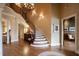 Spacious foyer with a curved staircase, chandelier, and hardwood floors leading to other rooms at 595 Legacy Falls N Dr, Chapel Hill, NC 27517