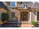 Close-up of an elegant arched wood front door framed by stone and brick detailing at 595 Legacy Falls N Dr, Chapel Hill, NC 27517