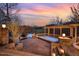 Relaxing outdoor hot tub area with pergola, stone patio, and serene water views at 595 Legacy Falls N Dr, Chapel Hill, NC 27517